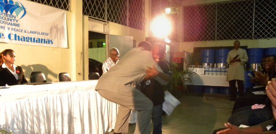 The Honourable Minister of National Security John Sandy embraces the youngest participant, Julian Smith