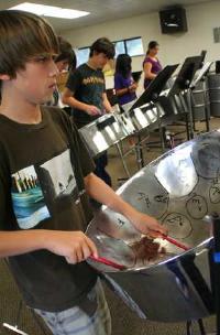Twelve-year-old Oakdale Junior High School student Samuel Cole practices on the steel drum that new district band instructor Ross McGinnis has brought to the school. Cole was interested in taking steel drum lessons after years of playing drums.