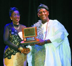 Former Minister of Culture Joan Yuille-Williams accepts the The Pan Trinbago Award from Pan Trinbago president Keith Diaz