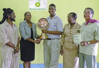 Rhonda Francis, second from left, manager, Corporate Responsibility, bpTT, presents the award for Most Outstanding Student in Basic Pan Tuning to Fatima College student, Brandon Francis. Sharing the special occasion are, from left, tutor Musa Muhammed; Betty Adams-Skeete, principal of Belmont Secondary School; and PDU founder and manager Barry Yeates