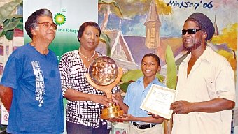 Ishmael Williams, student of St Margarets Boys AC, receives his award as Most Outstanding Student in the Introductory Pan Construction Course 2013 from Ronda Francis, manager, Corporate Responsibility, bpTT. Sharing in the moment are, left, Barry Yeates, manager of Pan Development Unlimited, and Musa Mohammed, tutor.