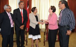 Prime Minister Kamla Persad-Bissessar, centre, hands over the cheque to Maureen Manchouk, Chairperson of the Steel FesTT Committee. Looking on from left, are Peter Kanhai, Chairman of the Sports and Culture Fund, Office of the Prime Minister, Brian Awang, and Brian Serrette, Vice-President of Pan Trinbago.