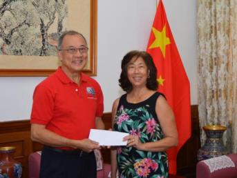Bernice Ho-Leanza, daughter of Susie Ho, making presentation to Kenneth Chang On, President of the T&T Chinese Steel Ensemble