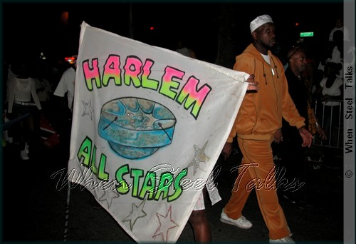 Harlem All Stars flagman proudly holds the bands flag in the 2003 African American parade