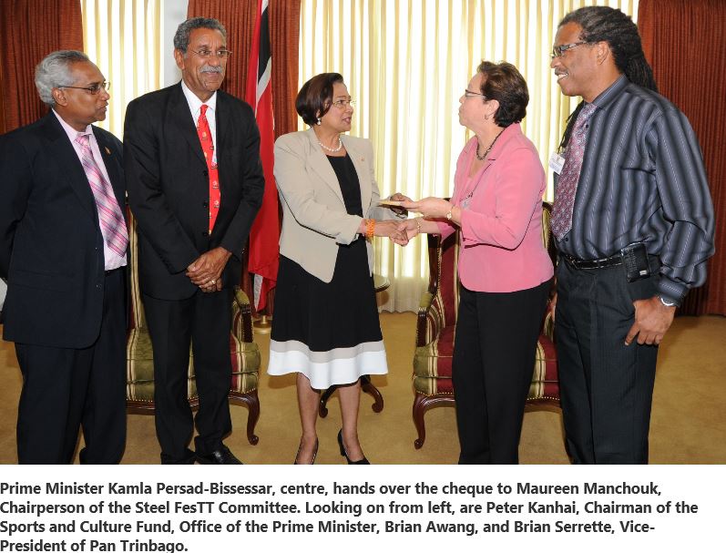 Prime Minister Kamla Persad-Bissessar, centre, hands over the cheque to Maureen Manchouk, Chairperson of the Steel FesTT Committee. Looking on from left, are Peter Kanhai, Chairman of the Sports and Culture Fund, Office of the Prime Minister, Brian Awang, and Brian Serrette, Vice-President of Pan Trinbago.