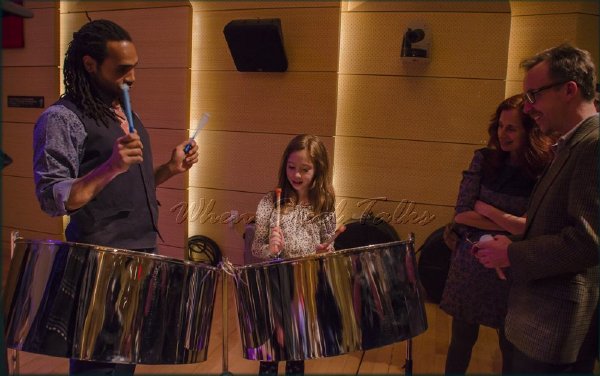 After the symposium, Khuent Rose interacts with a young attendee entranced with the double second steelpan - Tishman Auditorium at the New School, New York