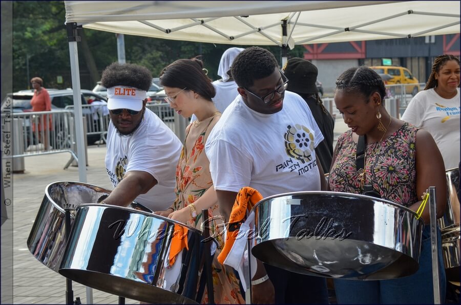 Trying their hand on the steelpan instrument under the guidance of Pan In Motion musicians on the Ticketmaster Plaza at Barclays Center