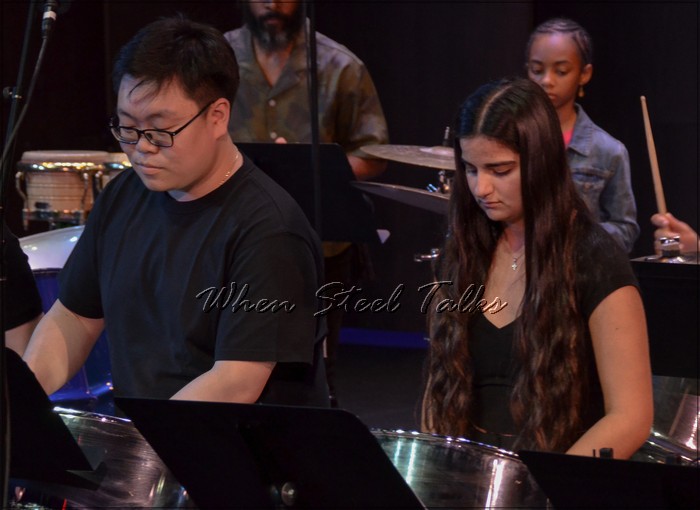 Jacky Xu, left, next to Anastasia Theodoropoulos and other fellow NYU Steel band mates, performing his arrangement of “Liberian Girl”