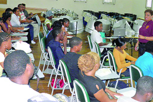 ALL EARS: A cross-section of participants listen attentively to facilitator Michelle Huggins-Watts at the bpTT-sponsored Panorama Arranging workshop at St Augustine Secondary School
