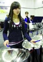 Catholic Central High School Grade 10 student Elaine Bird takes part in a music academy steel pan drum program in Sarah Harmon¹s class Tuesday in the school band room. Herald photo by David Rossiter
