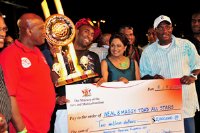  Prime Minister Kamla Persad-Bissessar, centre, and Arts and Multiculturalism Minister Winston"Gypsy "Peters, at right, present the $2 million winner's cheque to Dwayne Ifill of Panorama champion Neal and Massy Trinidad All Stars at the Queen's Park Savannah, Port of Spain, on Saturday night