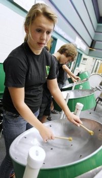 Rockport-Fulton Middle School students Elle Tucker, 12, (from left) and Cody Marr, 14, rehearse on Wednesday with members of the school steel drum band. The band was formed as part of the school's Gifted and Talented program