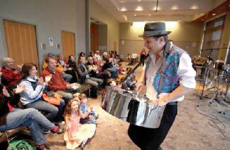 Percussionist Ian Dobson plays his steel drums made from old oil barrels for a wide array of parents and children who attended a demonstration last week at Puyallup Public Library in downtown Puyallup