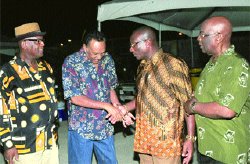 Pan people: Minister of Arts and Multiculturalism Winston "Gypsy" Peters, second from right, greets former government minister Eddie Hart at the of the 2012 Panorama launch held at the Queen's Park Savannah, in Port of Spain on Friday night. Looking on is Pan Trinbago President Keith Diaz, left, and National Carnival Commission chairman Patrick Arnold