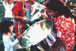 A young girl checks out one of the steelpans at an earlier performance by this steelpan player.