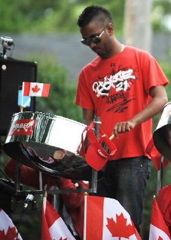 Kenrick Dookie, 28, plays a steel drum as his family's Pan Wave Steel Band plays in Sarnia's annual Canada Day parade. The Cambridge-based band was new to the Sarnia parade this year