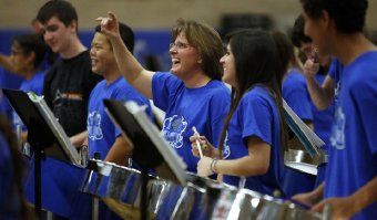 Tina Walton, director of bands at Catalina Foothills High School, signals her delight as the Blue Steel band performs