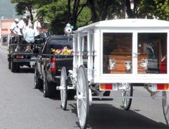 Members of the Sapophonics pan side lead the procession carrying the casket of master builder and pan tuner Herman Guppy Brown, following yesterdays funeral service at the Trinity Cathedral, Port-of-Spain. 