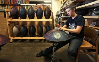 Jenny Robinson demonstrates how to play a handpan. Robinson founded Isthmus Instruments, LLC, on Madison's Far East Side to create the rare musical instruments, which have an otherworldly sound.