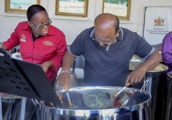 PLAYING MUSIC: Denise Rose of NSSO interacts with Bhola Verma, a member of the visiting Bhojpuri delegation from India.
