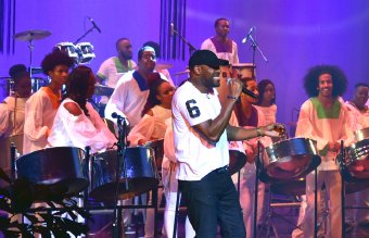 Soca artist Rodney "Benjai" Le Blanc accompanies Skiffle Bunch Steel Orchestra, while performing his hit song "Phenomenal" during the International Steelband Foundation concert titled "We Going Down Sando" held at the Southern Academy for Performing Arts (SAPA), San Fernando, on Thursday night.