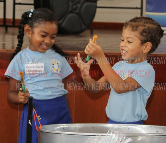 Arima New Government students Aiyana-Marie Jadoonanan and Samuel Berot, got musical with a steelpan at the Music Education Expansion Initiative project ceremony on Wednesday at the Arima New Government Primary School, Tumpuna Road South, Arima