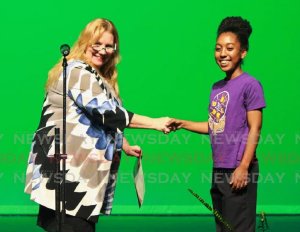 Dr. Jeannine Remy congratulates Jesse Jagnarine for placing first in the Steelpan Solo 21 Years and Under at the Music Festival at the Naparima Bowl in San Fernando