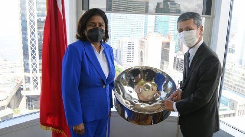 Ambassador Yutaka (right) plays the steelpan alongside Minister Gopee-Scoon following the courtesy call