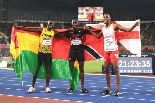 Jereem Richards of T&T, centre, wins the men's 200m finals in a time of 19.80 seconds ahead of England's Zharnel Hughes in 20.12, right, and Joseph Amoah of Ghana (20.19) in the Alexander Stadium at the Commonwealth Games in Birmingham, England, yesterday.
