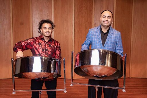 Liam Teague, a professor of music and director of steelpan studies at Northern Illinois University, right, with son, Jaden, during a recent performance