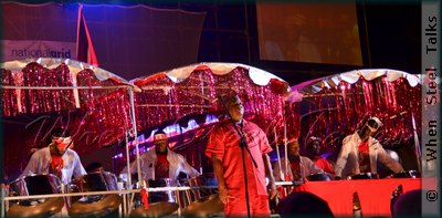 Arranger "BJ" Marcelle on stage with D'Radoes Steel Orchestra
