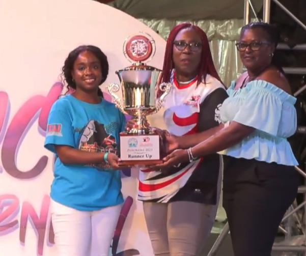 Pantime Steel Orchestra band member (left), being presented with the  trophy for second place by Pan Trinbago president Beverley Ramsey-Moore  (center), and St. Lucia National Steelbands Association president Perline Mathurin (right)