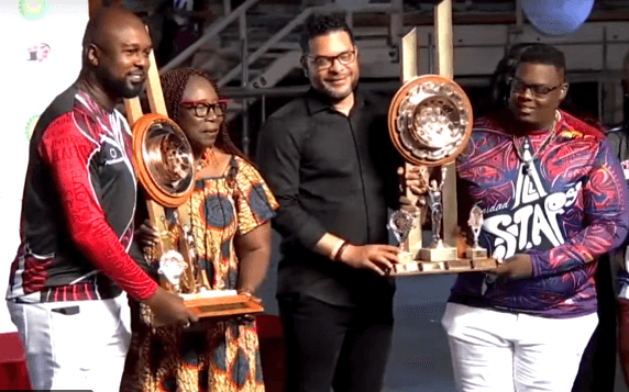 Left to right: Renegades’ representative with Pan Trinbago president Beverley Ramsey-Moore, Senator the Honourable Randall Mitchell, Minister of Tourism, Culture and the Arts, with Trinidad All Stars’ representative - holding championship trophies